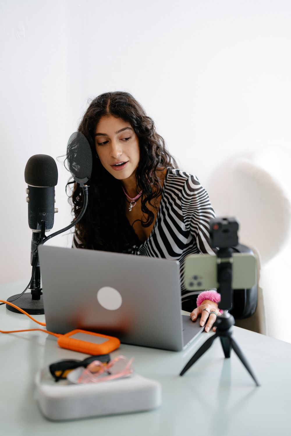 A content creator recording at her desk